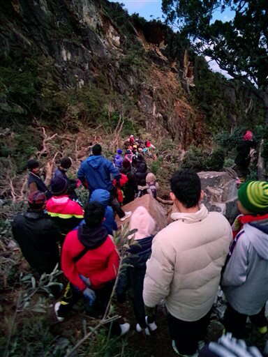 TREKKING TO SAFETY: Local mountain guides lead previously trapped climbers down the Timpohan Trail on Friday, June 5, 2015. Over 130 people have been rescued from danger as of Monday, June 8.